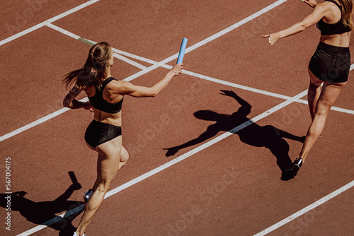 women relay race running for track and field competition