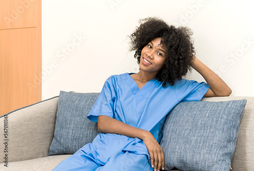 Young African American nurse in uniform sitting and relax on sofa, black female doctor sit on couch, Hospital Concept