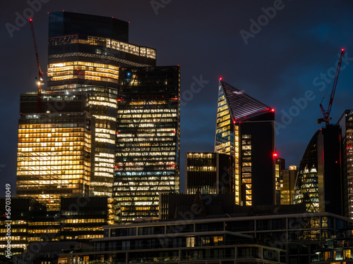 London, UK - City of London Financial District lit up at night with skyscrapers and office blocks early evening. Business HQ, Economy, GDP, Making money, Banking and Wall Street style concept