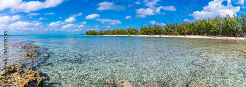 A panorama view from a rocky headland across a deserted bay on the island of Eleuthera, Bahamas on a bright sunny day