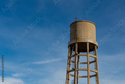 Old water storage tank isolated with blue sky