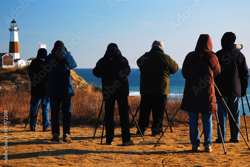 A group of bird watchers count and record the species on a cold winter day near the Montauk Point Lighthouse on Long Island