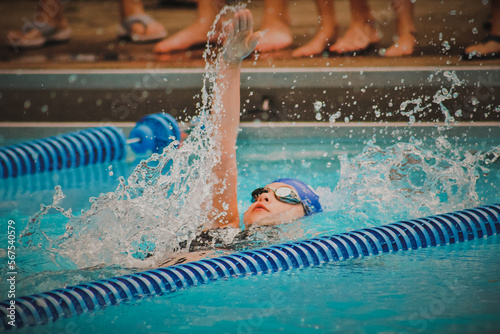 Girl swimming backstroke in pool