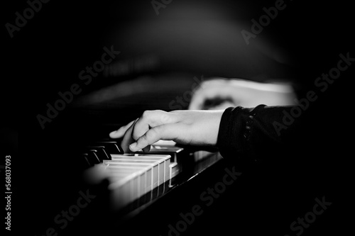 Pianist male hands playing music on piano keys.