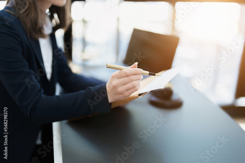 Portrait of a beautiful Asian lawyer studying a lawsuit for a client before going to court