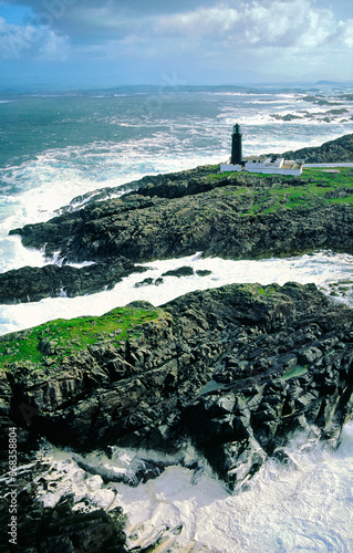 Stormy Atlantic weather. Slyne Head lighthouse marks the treacherous rocks of at southwest tip of Connemara, County Galway, Ireland. Aerial