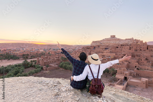 Couple of travelers on background Ait Ben Haddou ksar in Ouarzazate. Travel concept. Popular landmark..