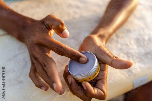 Close-up of male hands applying sun lotion