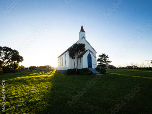 Old historic 19th century white presbyterian Awhitu Central Church with green grass, Manukau Heads Auckland New Zealand