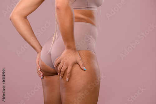 Close-up of young womans body, studio shoot.
