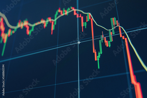 Diagram representing red crashing stock market volatility of crypto trading, where red candlesticks going down without resistance, market fear and downtrend on blue display background