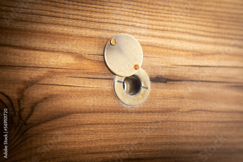  Peephole on a wooden door.