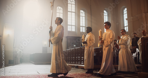 Liturgy in Grand Church: Majestic Procession Of Ministers And Priests Walking with Processional Cross. Congregation Stands In Reverence, Christians Rejoice In Ceremony of Mass