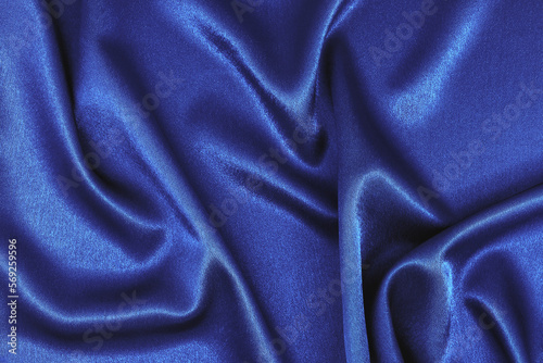 Texture of soft blue silk fabric. Smooth wavy fabric. Can be used as Elegant wallpaper design. Abstract background. Top View, Copy Space
