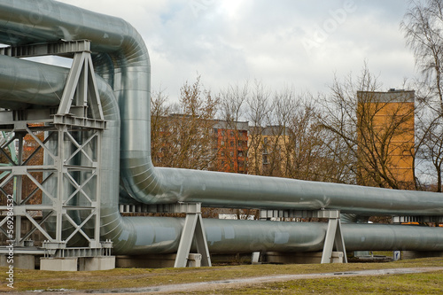 pipeline close-up, in the background are multi-storey buildings and a gray sky