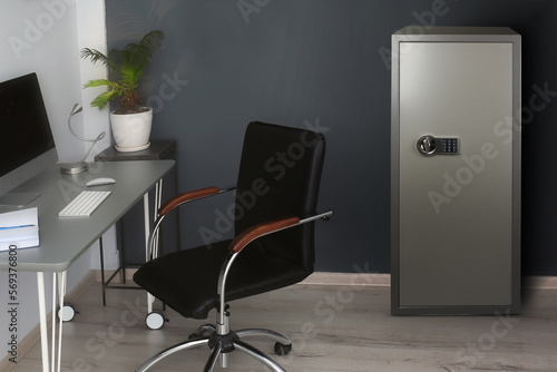 Big steel safe with electronic lock near workplace indoors
