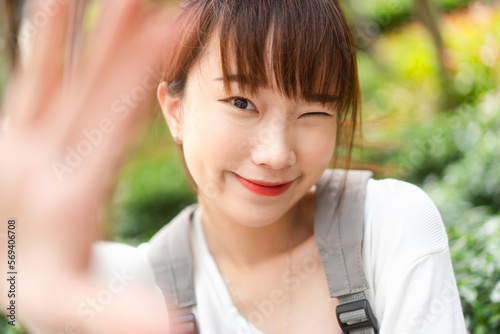 Portrait of young adult cute asian student woman take a selfie photo by mobile phone beauty face