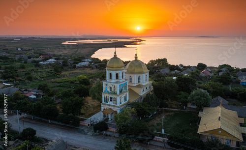 Orthodox lipovan church during sunrise next to a lake in Dobrogea Sarichioi village. Landmarks of Romania.
