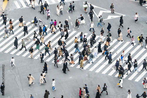 Crowded Japanese people, Asian traveler walk cross road at Shibuya scramble crossing. Tokyo tourist attraction, Japan tourism, Asia transport, commuter transportation or city life concept