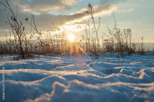 View of snow-covered hills with dry grass cover. Winter theme.