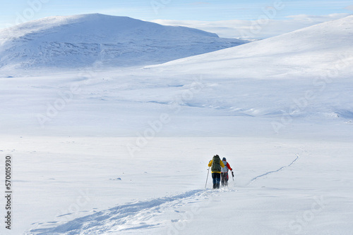 Hikers on snow shoe hiking on a beautiful sunny day at the mountain of Dovrefjell
