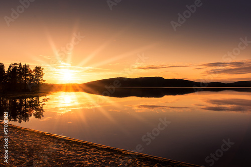 Peaceful landscape of Lake Inari with the midnight sun in Lapland, Finland