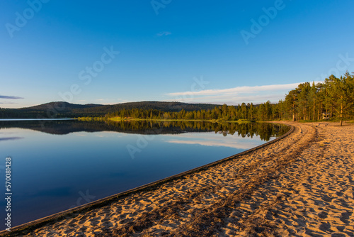 Peaceful landscape of Lake Inari with the midnight sun in Lapland, Finland