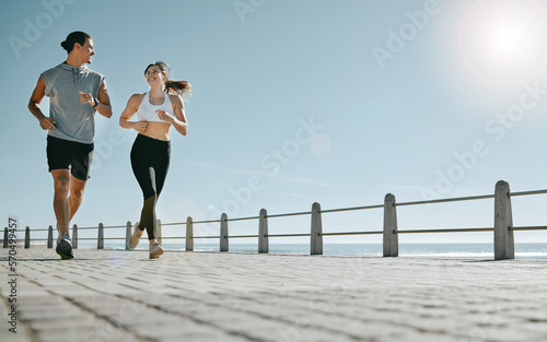 Couple, fitness and running by beach on mockup for exercise, workout or cardio routine together. Happy man and woman runner taking a walk or jog for healthy wellness or exercising in Cape Town