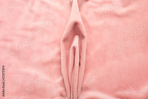 Pink soft fabric shaped as female genital organs, vulva and labia, vagina concept