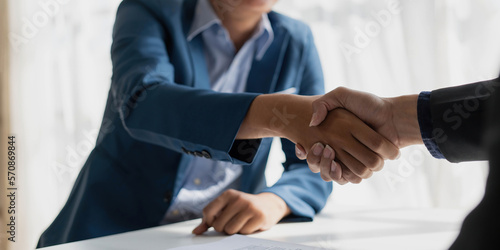 Handshake of cooperation customer and salesman after agreement, successful car loan contract buying or selling new vehicle