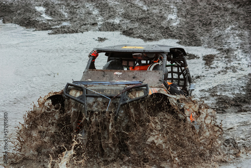 athlete on a ssv rides in the mud