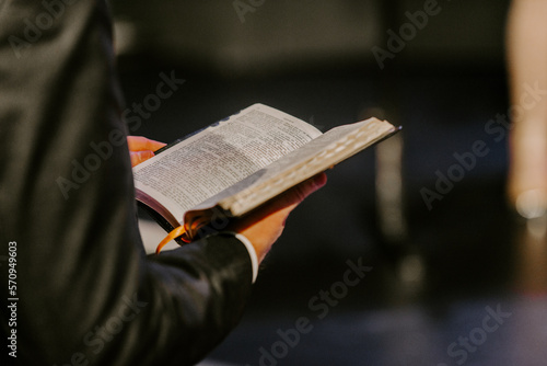 Pastor with a Bible in his hand during a sermon. The preacher delivers a speech