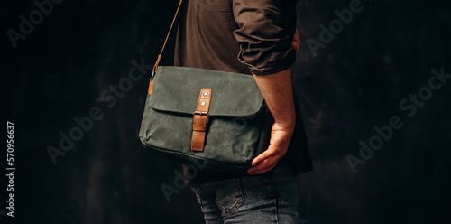 Man with duffle bag on shoulder. leather and canvas bag