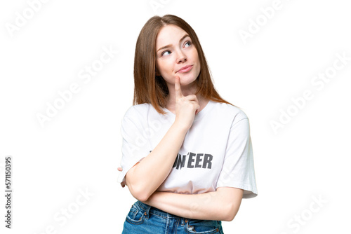 Young volunteer woman over isolated chroma key background having doubts while looking up