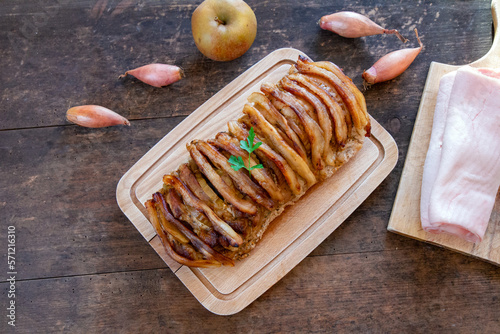 Pork loin baked with apples, shallots and lard plasters