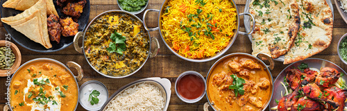 indian food feast with chicken tikka masala curry, tandoori chicken and appetizers