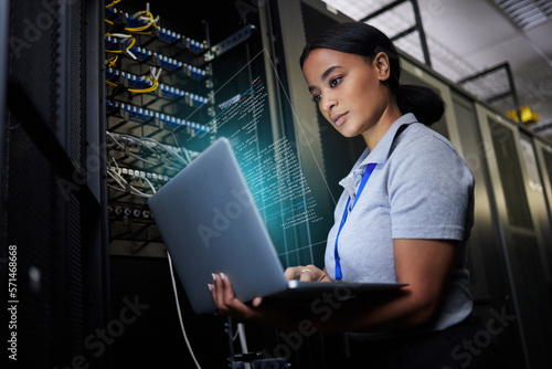 Laptop, network and data center with a black woman it support engineer working in a dark server room. Computer, cybersecurity and analytics with a female programmer problem solving or troubleshooting