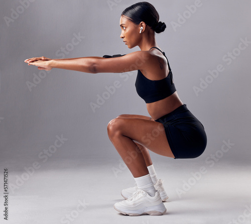 Exercise, black woman and squat for training, workout and fitness for health, wellness and grey studio background. Female, lady and athlete bending, stretching and practice for endurance and energy