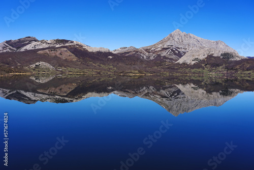 View since the Viewpoint of the porma reservoir, in the province of leon, on a sunny day with the Susarón peak and mountains reflected in the water of the reservoir. Castilla y Leon, Spain.