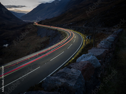 Glen Coe at night with car light trail