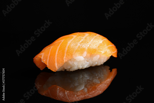 Delicious nigiri sushi with salmon on black background