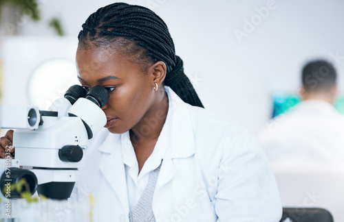 Medical science, black woman and microscope in laboratory for research, analytics and medicine. Woman, doctor and scientist study at work for an investigation, healthcare and futuristic mock up space