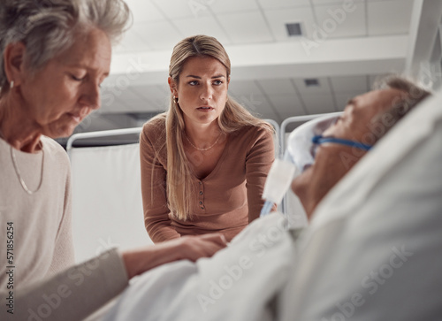 Sick, senior and family with a man in hospital for medical support with sad and worried people. Healthcare, ill and woman and daughter with an elderly patient after an accident, injury or dying