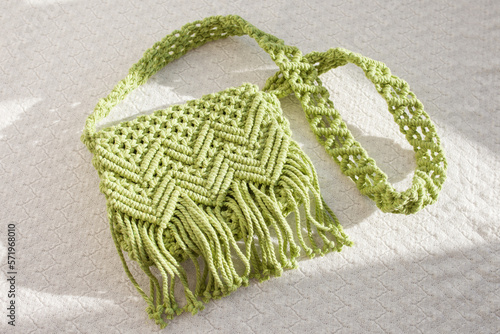 Handmade macrame cotton сross-body bag. Eco bag for women from cotton rope. Scandinavian style bag. Light green color, sustainable fashion accessories. Details. Close up image