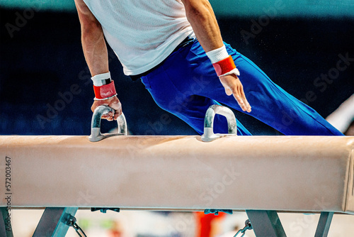 gymnast athlete exercise on pommel horse gymnastics