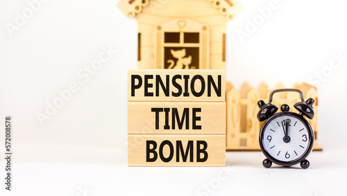 Pension time bomb symbol. Concept words Pension time bomb on wooden blocks on a beautiful white table white background. Black alarm clock, house model. Business pension time bomb concept. Copy space.