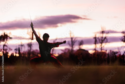 martial arts mid latin woman wushu kung-fu sword. healthy wellness active training. argentinean.