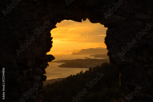 Sunset over the mediterranean from rock window