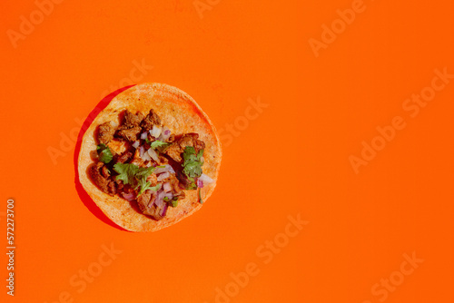 Esthetic flash food photography of Mexican taco table setting with shadows on bright color background