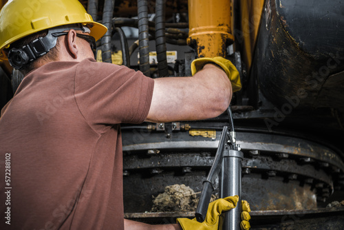 Industrial Machine Technician Pumping In the Grease